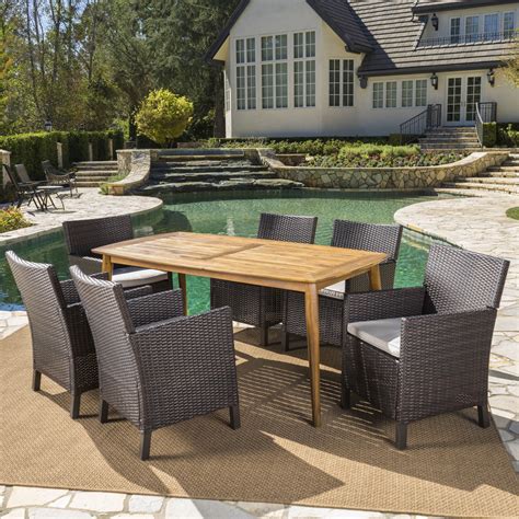 Remy Outdoor 7 Piece Wicker Dining Set With Teak Finished Round Acacia