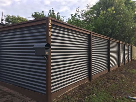 Corrugated metal may not be the first thing that pops into your mind when thinking about an attractive accent for the yard. corrugated iron and hardwood fence | Privacy fence designs ...