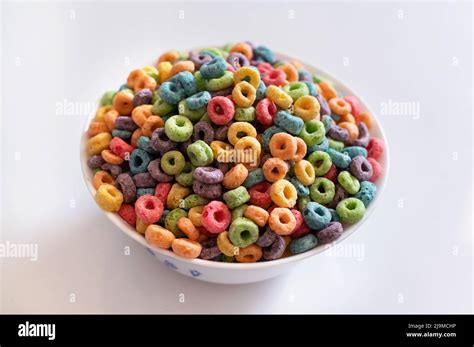 Delicious And Nutritious Fruit Cereal Loops With Milk On White