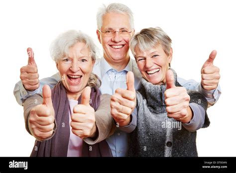 Three Happy Senior People Holding Their Thumbs Up Stock Photo Alamy