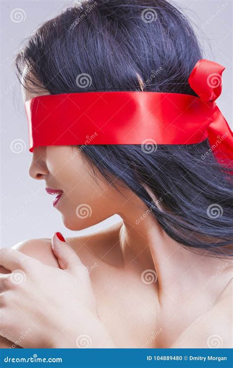 Caucasian Brunette Woman Posing With Red Ribbon Blinder On Eyes Stock