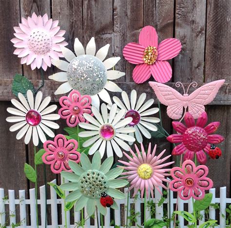 Whether you prefer to have them stand alone or covered in climbing vines, you can never go wrong with a trellis for garden use. Pink & White Metal Flower Garden Stakes w/Butterfly
