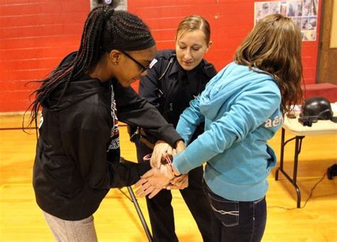 Police Officer Demonstrates Student How To Properly Handcuff Her Friend