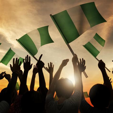Silhouettes Of People Holding Flag Of Nigeria Pai