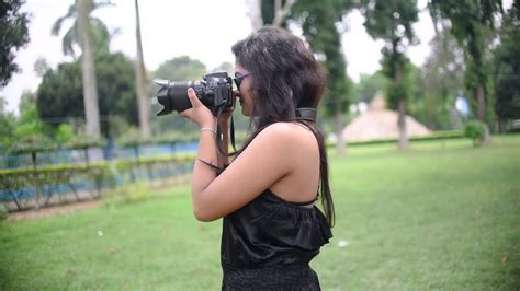 Premium Stock Video A Tourist Asian Girl Takes Photograph With A Dslr Camera At A Nature Park