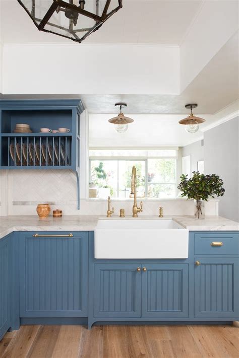 The kitchen has an island in the middle made in a similar style. 25 Stylish And Inspiring Blue And White Kitchens - DigsDigs