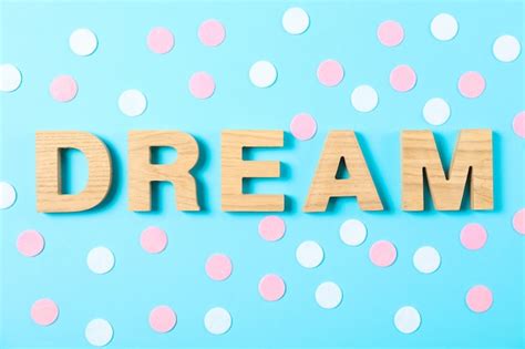 Premium Photo Dream Word Made From Wooden Letters On Blue Dotted