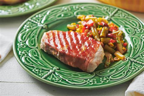 Pork chops are cooked to a safe temperature when a thermometer inserted into the thickest part of the meat registers 145 degrees f. Grilled Prosciutto Wrapped Pork Chops Recipe — The Mom 100