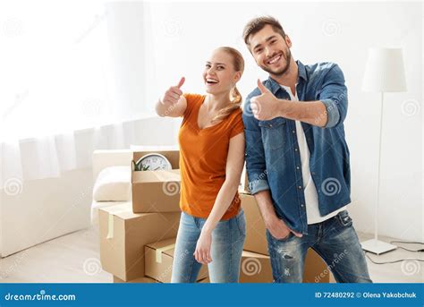 Young Couple Moving Into Their New Home Stock Photo Image Of Happy