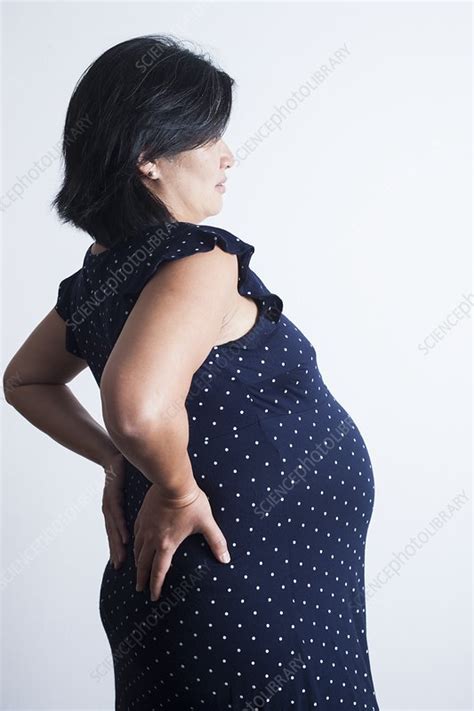 Sciatic nerve is a nerve fiber that begins in the lower back and ends in the lower limb. Pregnant woman with lower back pain - Stock Image - F031 ...