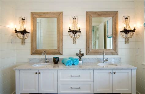 If you have one of these very common mirrors, there are tons of ways you can upgrade them on a budget. bathroom with wood framed mirrors and shell sconce ...