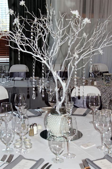 Silver wedding decorations, spray paint branches white/silver and put in pots outside venue with fairy lights and snowflakes hanging off!!! Manzanita centerpiece, Grey Silver White bling wedding ...