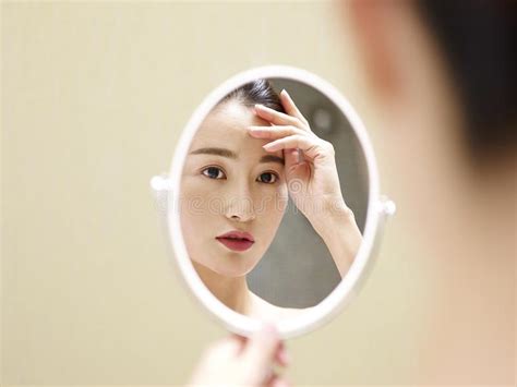 Young Asian Woman Looking At Self In Mirror Stock Photo Image Of