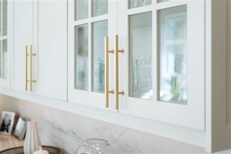 Free shipping on qualified orders. Brushed gold hardware on white cabinets with glass doors ...