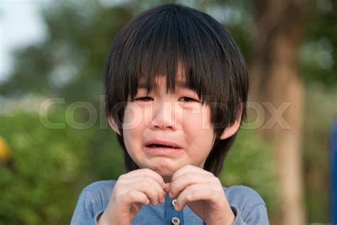 Asian Boy Crying In The Park Stock Image Colourbox