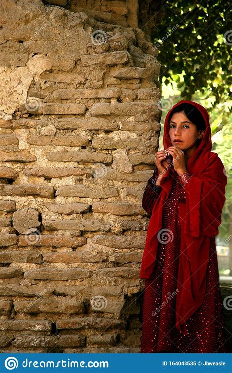 A Traditional Afghan Girl In A Red Dress In Balkh