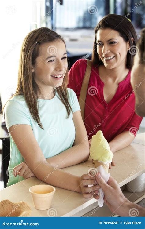 Mother Looking At Daughter Receiving Ice Cream Cone From Waiter Stock Image Image Of Food