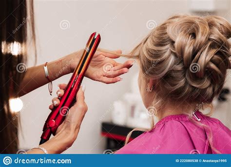 A Girl Hairdresser Makes A Clientand X27s Hair For A Celebration With