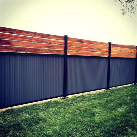 The new fence provides a shiny backdrop to your garden while blocking the neighbor's view. corrugated metal and wood fence best corrugated metal fence ideas on metal fence metal fences ...