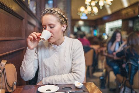 Portrait Of Woman Sipping Coffee In A Cafe By Stocksy Contributor