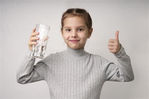 Cute Little Girl Drinking Water From Glass Close Up Stock Image