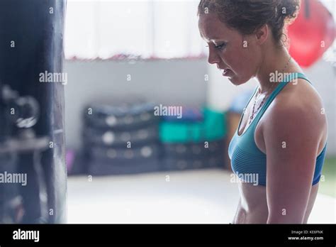 Tired Female Boxer Resting At Punching Bags In Gym Stock Photo Alamy