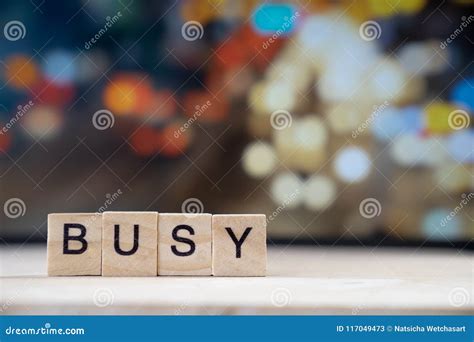 Busy Word Written In Wooden Cube On Wood Table With Traffic Bokeh In