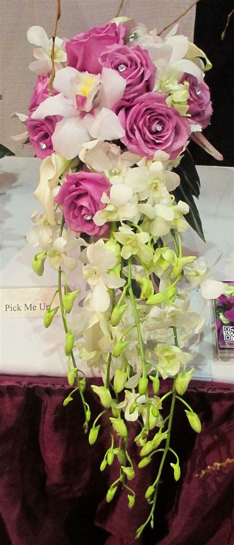 cascade bouquet with white dendrobium orchids pink cymbidium orchids purple roses with diamond