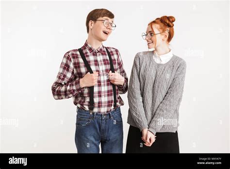 Shy Couple Of School Nerds Flirting Isolated Over White Background