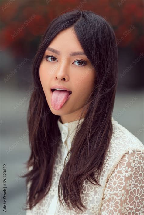 Beautiful Asian Woman Showing Tongue Stock Photo Adobe Stock