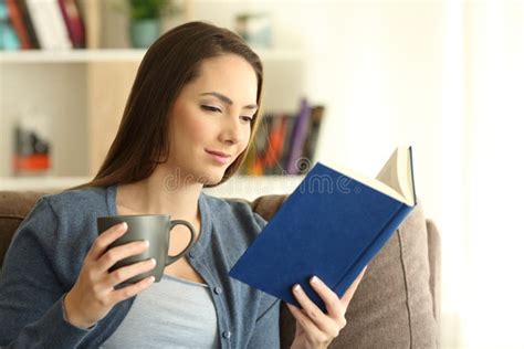 Relaxed Lady Reading A Book And Holding A Mug Stock Image Image Of