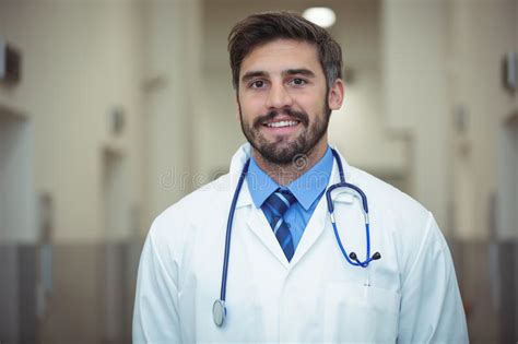 Portrait Of Male Doctor Standing In Corridor Stock Image Image Of