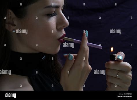 Portrait Of The Beautiful Elegant Girl Smoking Cigarette Isolated On Dark Background With
