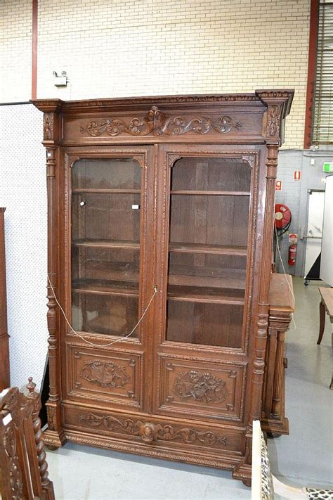 These bookcase doors are awkward to handle. Antique French Henri II carved oak two door bookcase ...