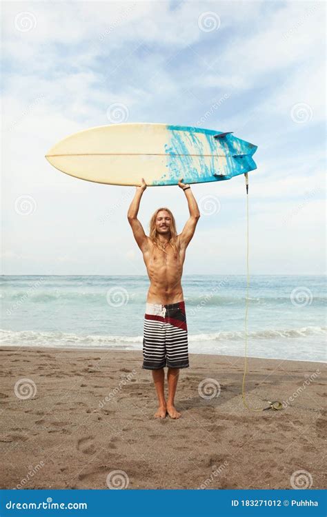 Surfing Handsome Surfer Holding White Surfboard Above Head Smiling