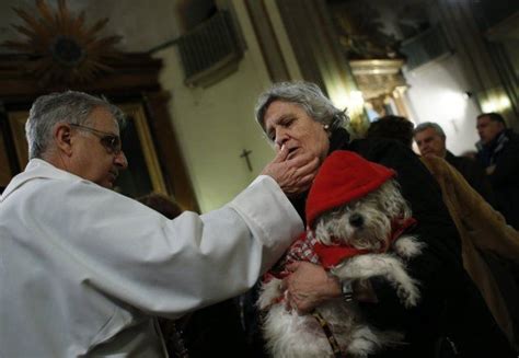 Thanks to for her assistance. A woman receives communion as she holds her pet during a ...