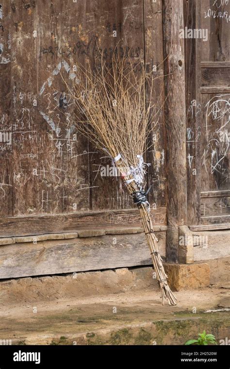 A Traditional Broom Made Of Small Branches Leaning Against A Building