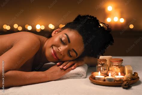 Foto De Smiling African Woman Lying On Massage Table At Spa Do Stock Adobe Stock