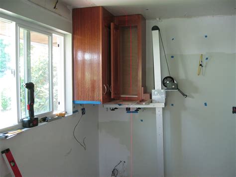 How to install kitchen base cabinets. UPPER CABINET INSTALLATION