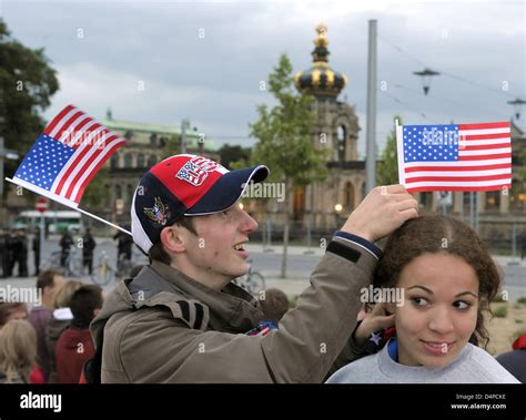 A Young Man Fixes A Us Flag To The Head Of His Companion Shortly Before