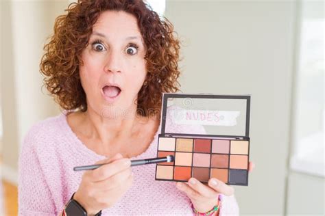 Senior Woman Showing Nudes Eyeshadows Colors Scared In Shock With A
