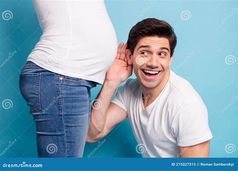 Cropped Photo Of Impressed Man Hug Listen Baby Pushing In Stomach Hand