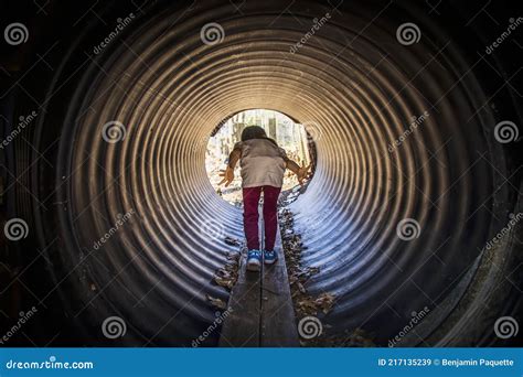 Little Child Going Through A Tunnel In A Playground Stock Image Image