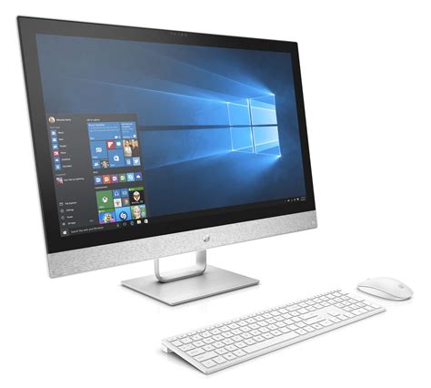 A Desktop Computer Sitting On Top Of A White Desk Next To A Keyboard