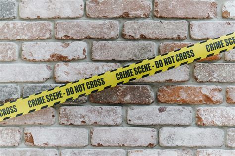 Crime Scene Tape On Brick Wall Stock Photo