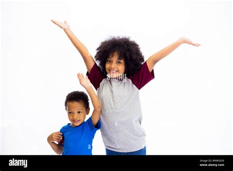 Smiling Young African American Sister And Brother Raising Hands