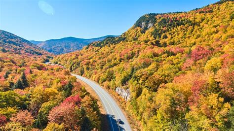 Aerial Over Stunning Road Through New Hampshire Mountains During Peak