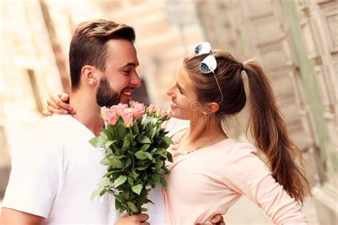 Happy Romantic Couple With Flowers Stock Photo Image 56983268