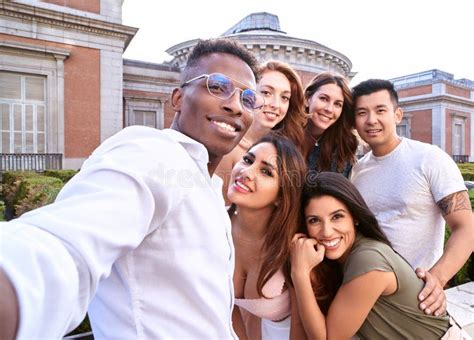 Group Of Multiracial Friends Smiling While Taking A Selfie Together