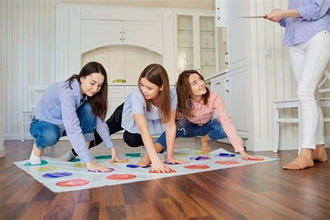 A Group Of Friends Play In Games On The Floor Indoors Stock Image